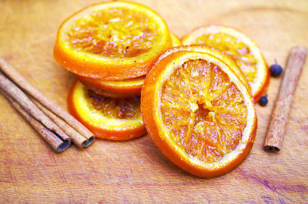 Candied fruits from orange slices, cinnamon sticks and fragrant  - Zdjęcie, obraz