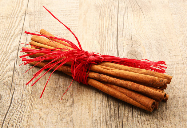 sticks of cinnamon in wooden background - Photo, Image