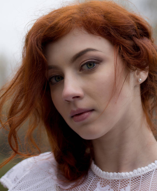 Beautiful young woman with red hair. Portrait. - Фото, зображення