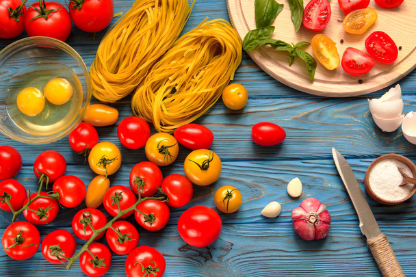 Ingredients for cooking pasta on a wooden table.  - Fotoğraf, Görsel