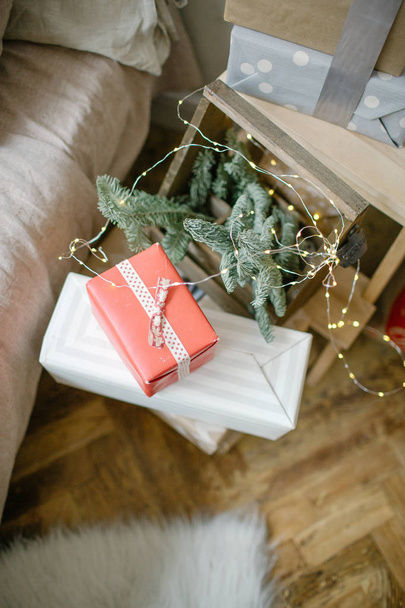 Gifts in boxes on the floor with pine tree branch - Фото, изображение