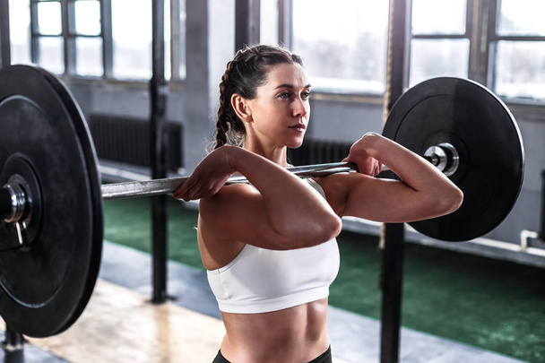 Sporty athletic woman in crossfit gym - Foto, Bild