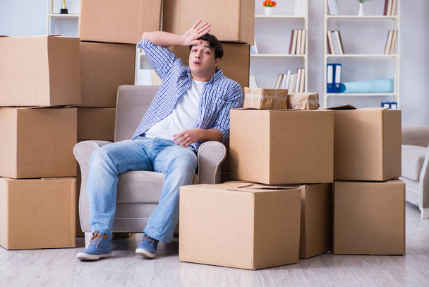 Young man moving in to new house with boxes - Photo, Image