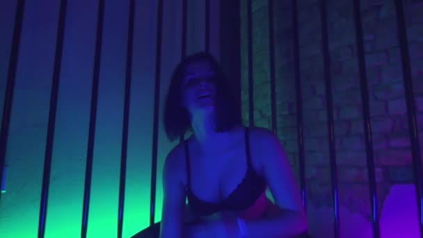 Sexy young bob cut brunette girl in black lingerie erotic moves in metal cage - Filmagem, Vídeo
