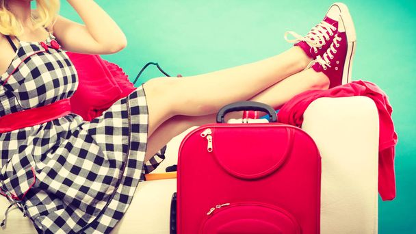 Woman relaxing after packing suitcase for vacation - Foto, Imagem
