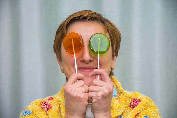 girl with candy , lollipops on sticks, closes his eyes - Photo, image