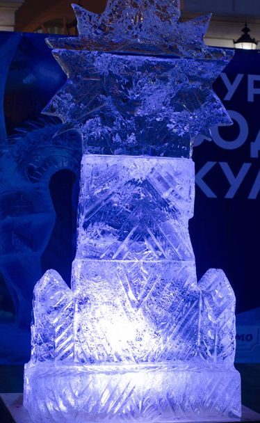 Sculptures cut out of ice. Art object. Ice figure highlighted with colored light. - Photo, Image
