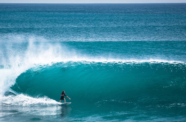 Surfer riding longboard on big green wave at Balangan beach, Bali, Indonesia - Photo, Image