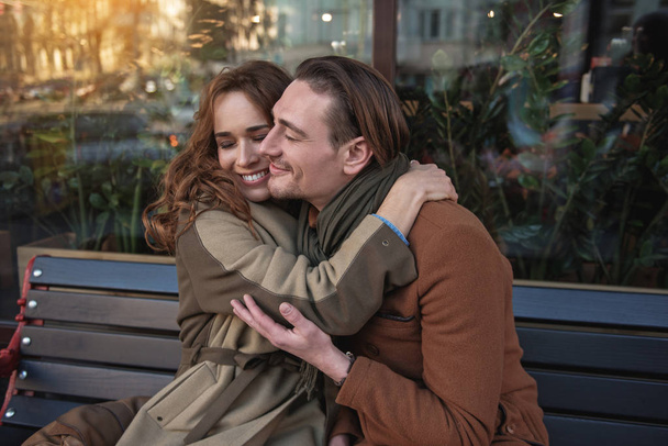 Cheerful man and woman cuddling outdoor - Fotoğraf, Görsel