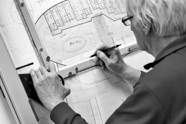 Senior architect working on drawing board - Photo, Image