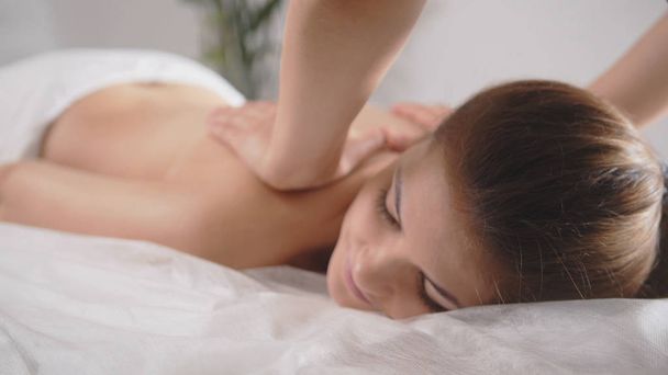 Young woman model receiving relaxing massage in spa room - Photo, Image