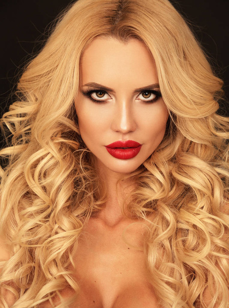 beautiful woman with blond curly hair and bright makeup posing i - Photo, Image