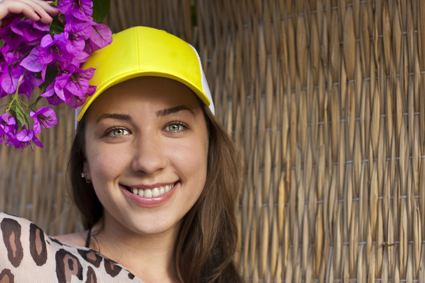 Sexy woman with baseball cap smiling - Fotó, kép