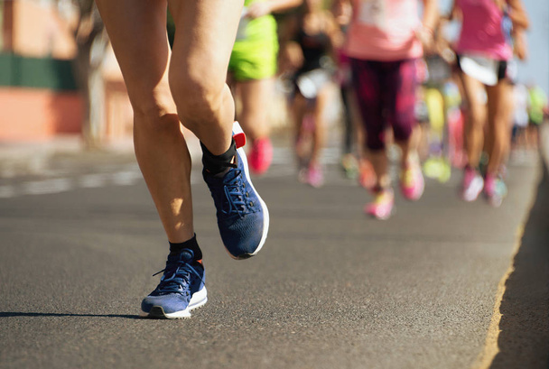 Marathon runners running on city road,detail on legs - Photo, Image