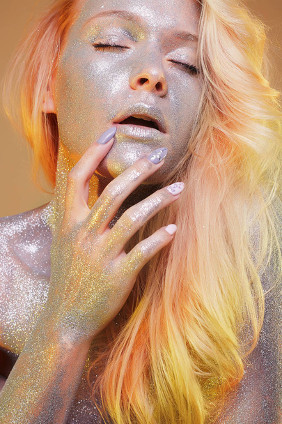 Beautiful Woman with Sparkles. Colorful Makeup and hair - 写真・画像