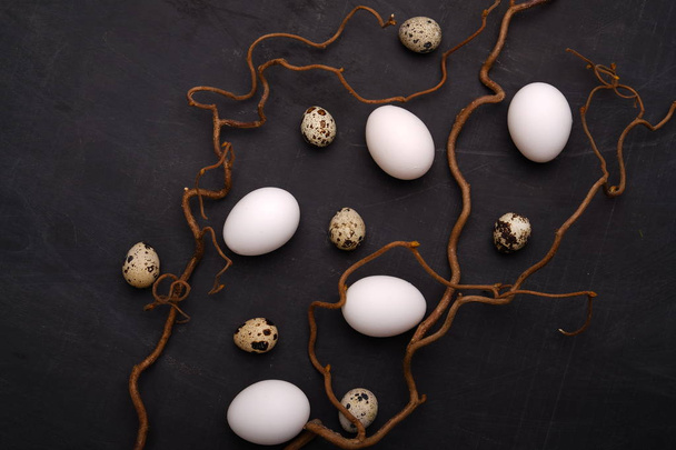Stylish eggs with decorative elements on black background. - Fotoğraf, Görsel