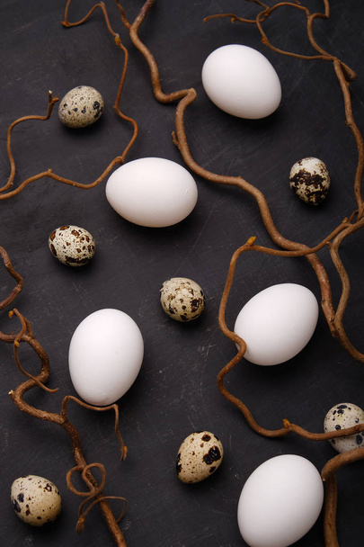 Stylish eggs with decorative elements on black background. - Фото, изображение