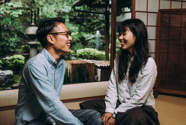 Young japanese couple spending time in their house - Фото, изображение