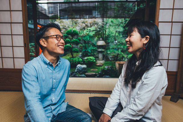 Young japanese couple spending time in their house - Фото, изображение