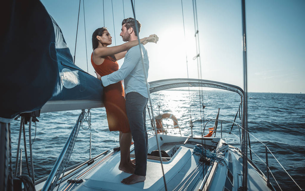 happy couple taking a romantic cruise on the sail boat - 写真・画像