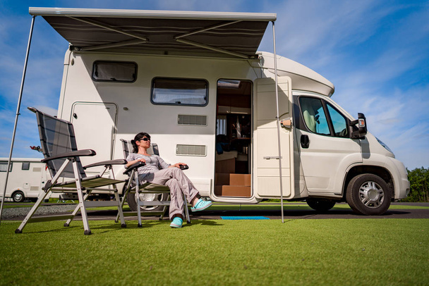 Woman resting near motorhomes in nature. Family vacation travel, - Foto, immagini