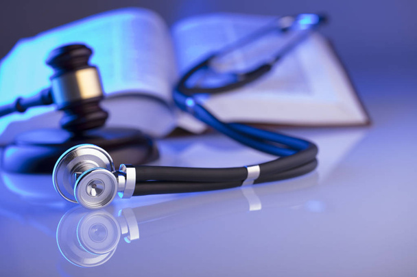 Medical law concept. Gavel, stethoscope, blue light. Place fort text. - Photo, Image