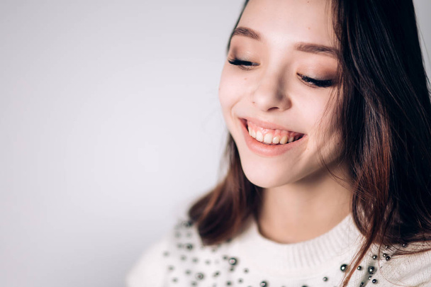 Beautiful smiling young woman closeup. Happy girl laughing on white background. Positive emotion. - Zdjęcie, obraz