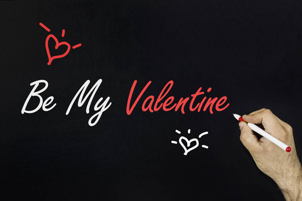 2018 Love concept. Male's hand writing text: Be my valentine on blackboard. - 写真・画像