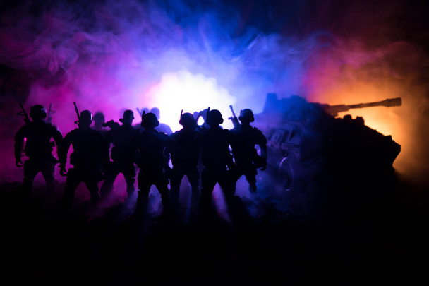 War Concept. Military silhouettes fighting scene on war fog sky background, World War Soldiers Silhouettes Below Cloudy Skyline At night. Attack scene. Armored vehicles. Tanks battle. - Photo, Image