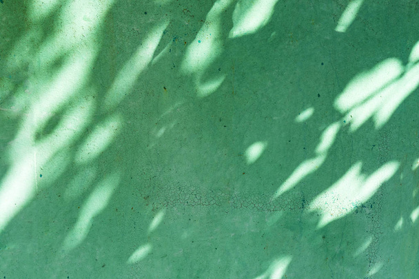 Background of a green metal sheet with a light-shadow pattern. - Fotó, kép