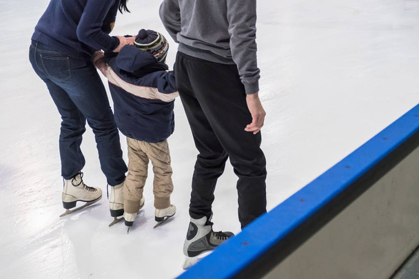Happy family indoor ice skating at rink. Winter - Zdjęcie, obraz