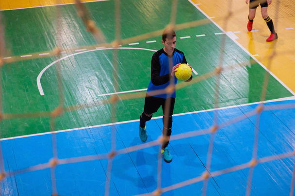 Football goalkeeper on goal, field, Futsal ball field in the gym indoor, Soccer sport field - 写真・画像