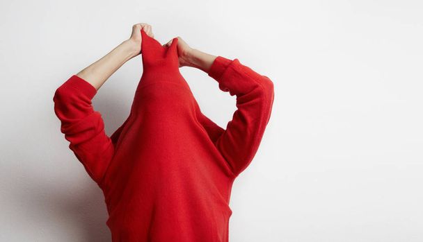 Portrait of woman wearing a red sweater stressed because work isolated on white background. Businessman concept. - Фото, зображення