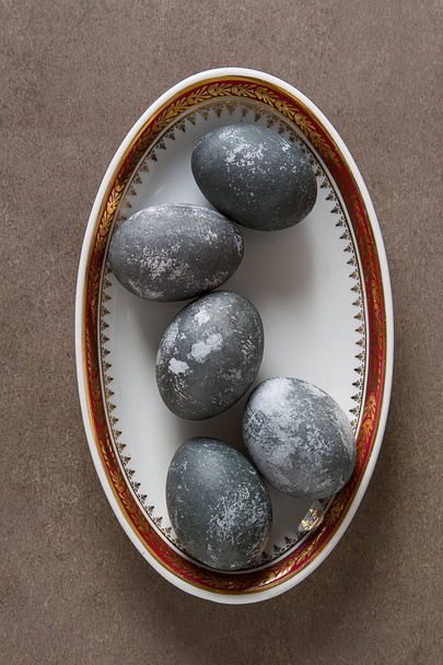 Easter composition with gray eggs on a colored background, space - Photo, image