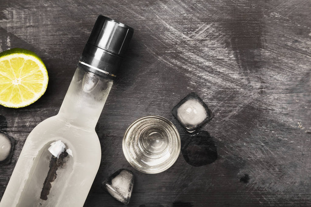 Cold vodka in shot glasses on a black background. Top view, copy - Foto, imagen