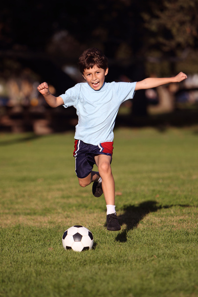 Boy playing soccer in the park - Photo, Image