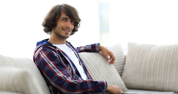 handsome successful guy sitting on the couch. - Photo, Image