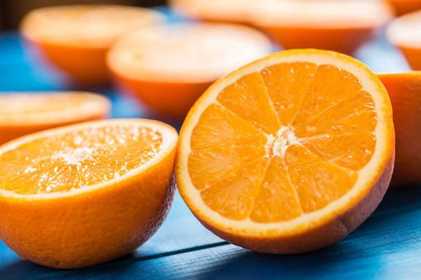 Oranžová. Horní části pohledu řezu čerstvé pomeranče na modrý stůl - Fotografie, Obrázek