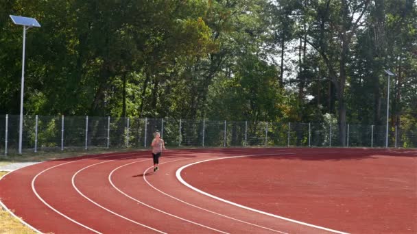 Pályán futó nő lány fut a stadion, 4k - Felvétel, videó