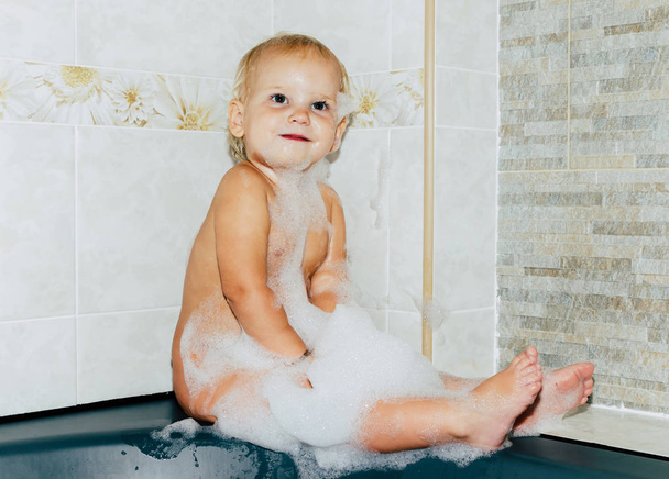 cute baby taking a bath with foam - Fotó, kép