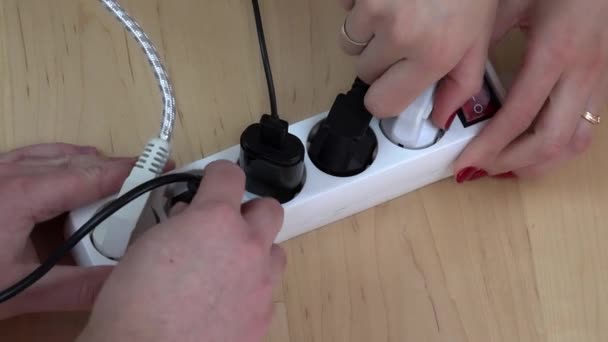 woman and man hands turn off electricity extension switch and unplug wires. - Footage, Video