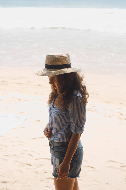 Girl in a hat on the beach  - Fotó, kép