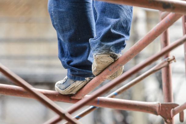 Industrial worker labourer on scaffolding, construction site. - Valokuva, kuva