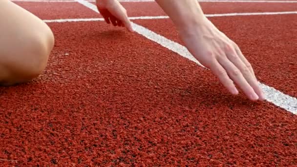 Close detail of track runner putting hands at starting line - Footage, Video