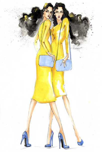 Two fashionable girls with handbags in yellow dresses. - Фото, зображення