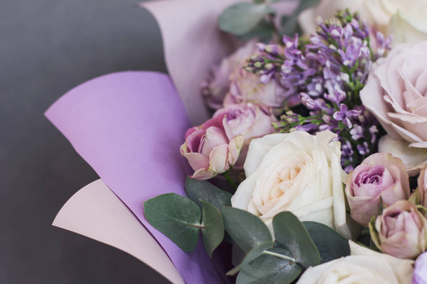 Lilac and eucalyptus in a large delicate bouquet on gray background - Photo, Image