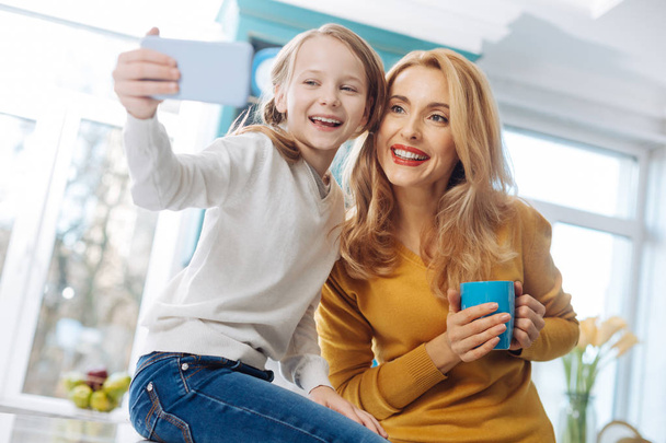 Content mother and daughter taking selfies - Valokuva, kuva