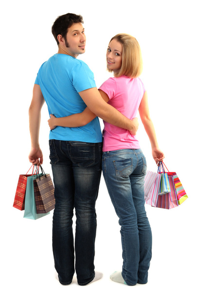 Young couple shopping and holding many shopping bags isolated on white - Fotoğraf, Görsel