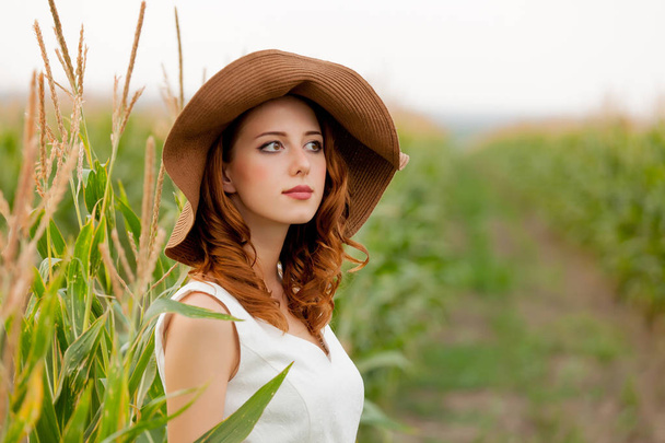 Young girl in hat at corn field at countryside outdoor. - Photo, Image