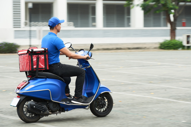 Courier on the scooter delivering food - Photo, Image